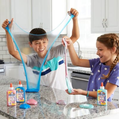 Two children making slime with Elmer’s glue at home on kitchen counter – fun DIY slime activity for kids