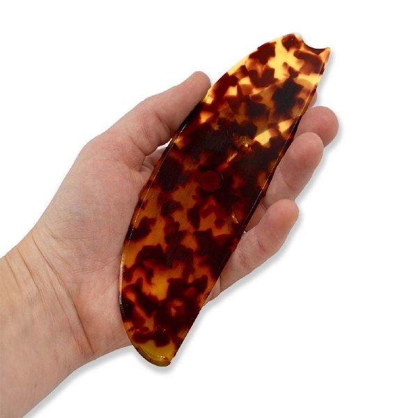 Flux Throwing Rib F1 held in potter’s hand for scale