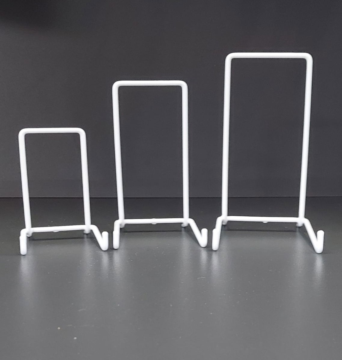 Set of three 5.5-inch wire plate stands for showcasing pottery and decorative plates.