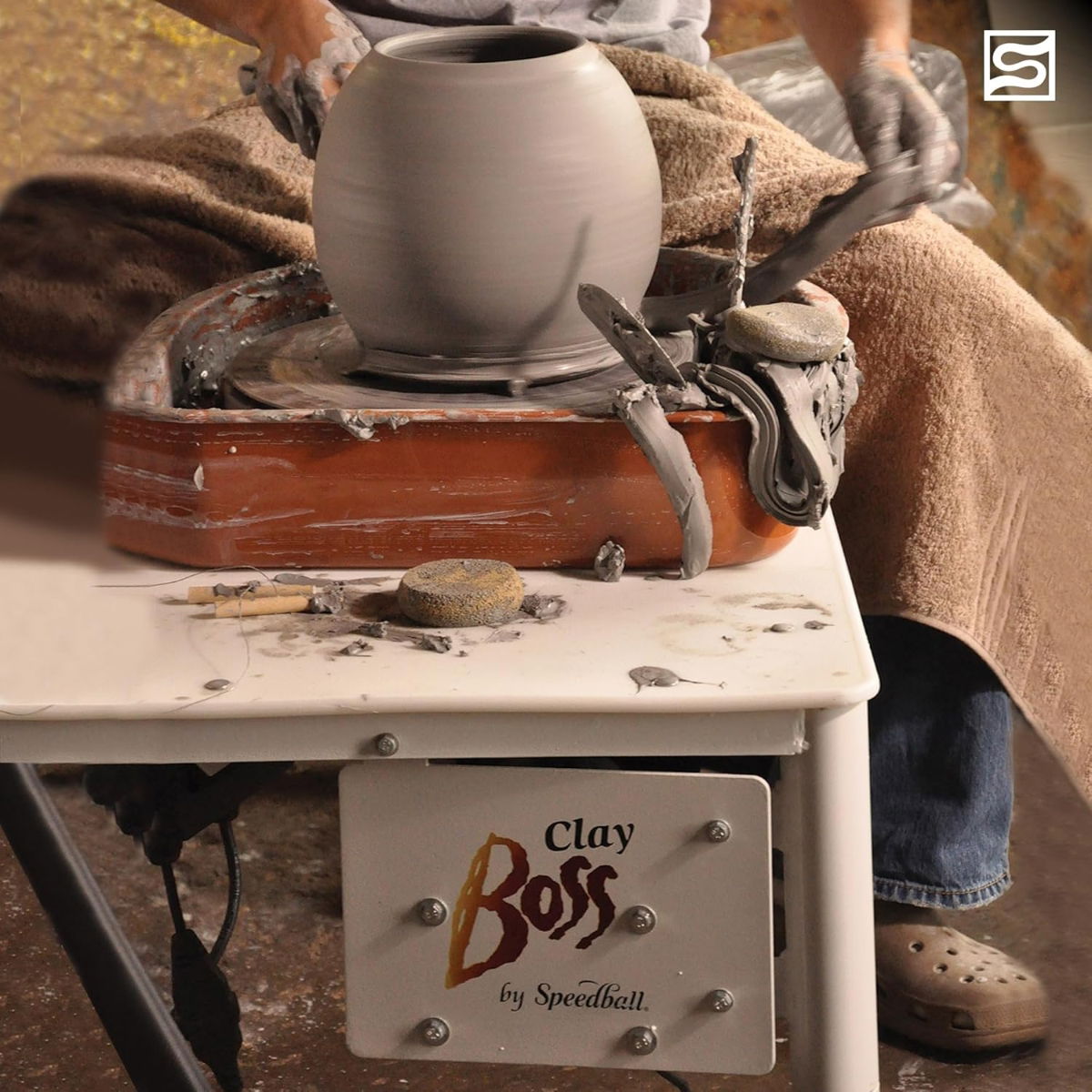 Close-up of potter throwing clay on Speedball Clay Boss wheel with splash guards